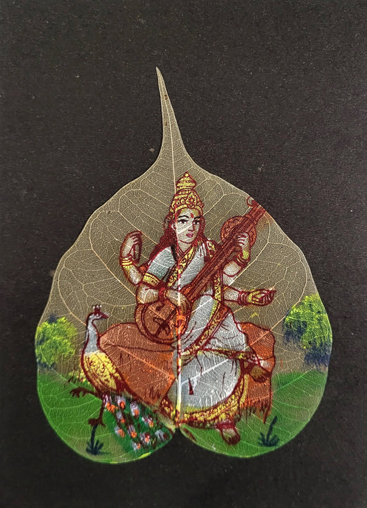 Saraswati_Leaf_Art,Handcrafted_Painting,Spiritual_Aura,Natural_Leaf_Canvas,Goddess_of_Knowledge,Folk_Art,Vibrant_Wall_Decor,Artisan_Craft,Unique_Wall_Art,Hindu_Deity,Celestial_Melodies,leaf_art,indian_god_painting